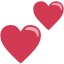 An emoji of two pink heart shapes.