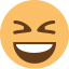 A laughing yellow face emoji with squinted eyes.