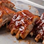 Oven baked barbecue pork ribs on a baking sheet