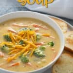Broccoli cheddar soup in a white bowl. Text at top reads, "Broccoli Cheddar Soup".