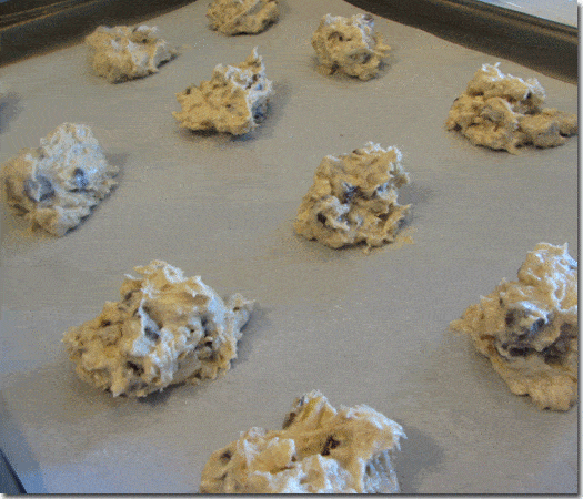 Raw cookies on a baking sheet lined with parchment paper.