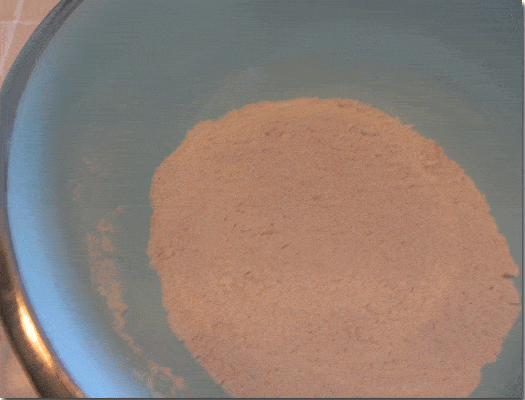 Closeup of flour mixture in a blue bowl.