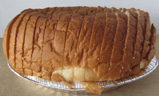 Sliced Hawaiian bread on an aluminum tray.
