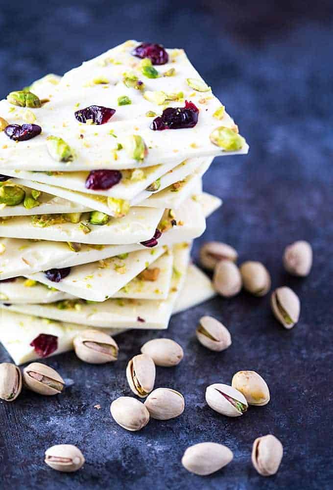 Front view of a stack of white chocolate bark with pistachios and cranberries.