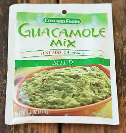 A packet of guacamole mix on a wooden background.