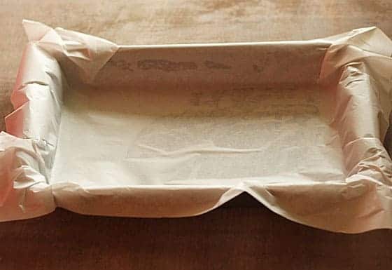 A rectangle baking pan lined with parchment paper.