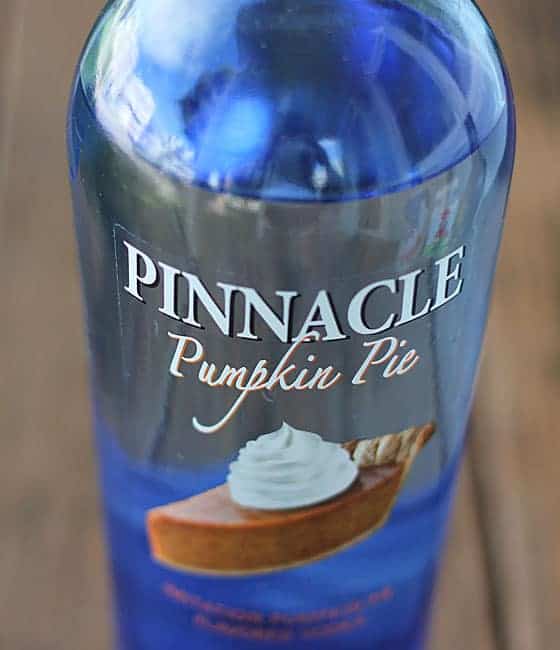 A blue vodka bottle with an image of a slice of pumpkin pie on the label.
