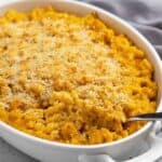 Baked pumpkin mac and cheese in an oval white baking dish