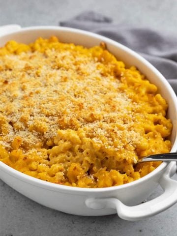 Baked pumpkin mac and cheese in an oval white baking dish