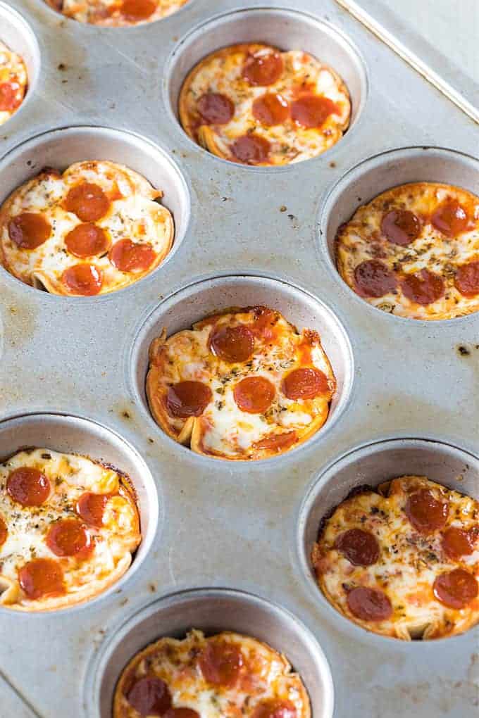 Baked appetizer pizzas in a cupcake tin.