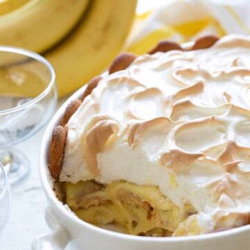 Easy banana pudding topped with meringue in a white oval baking dish