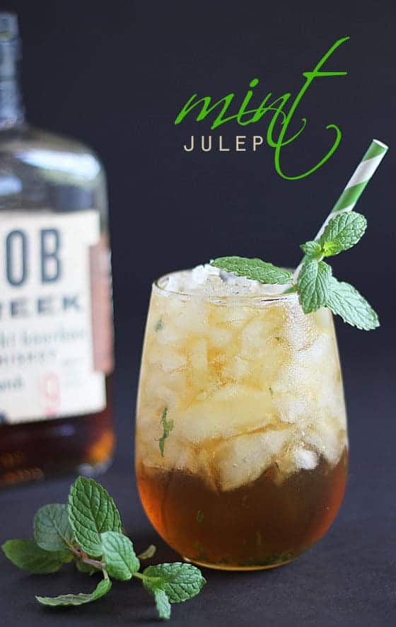 A bourbon cocktail with crushed ice garnished with fresh mint. Text at top of image.