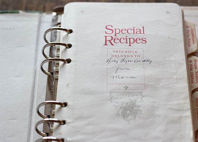 A handwritten cookbook opened to the first page.