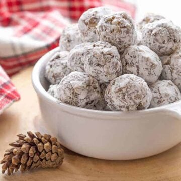 Date balls in a white bowl on a wooden trivet