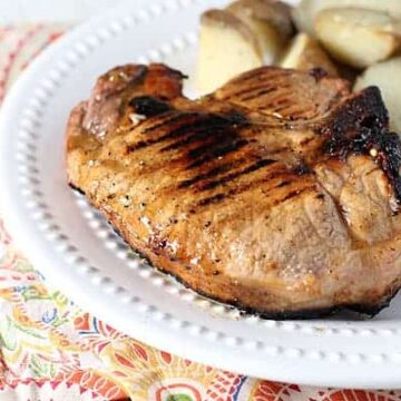 Grilled pork chops in an easy marinade prepared with peach preserves.
