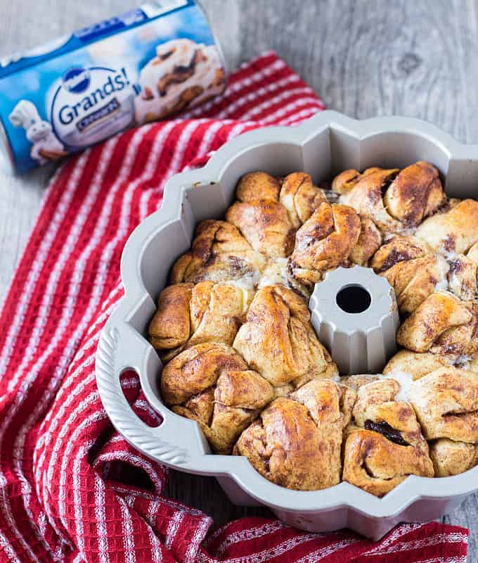 Overhead view of baked monkey bread in a bundt pan by a red striped napkin.