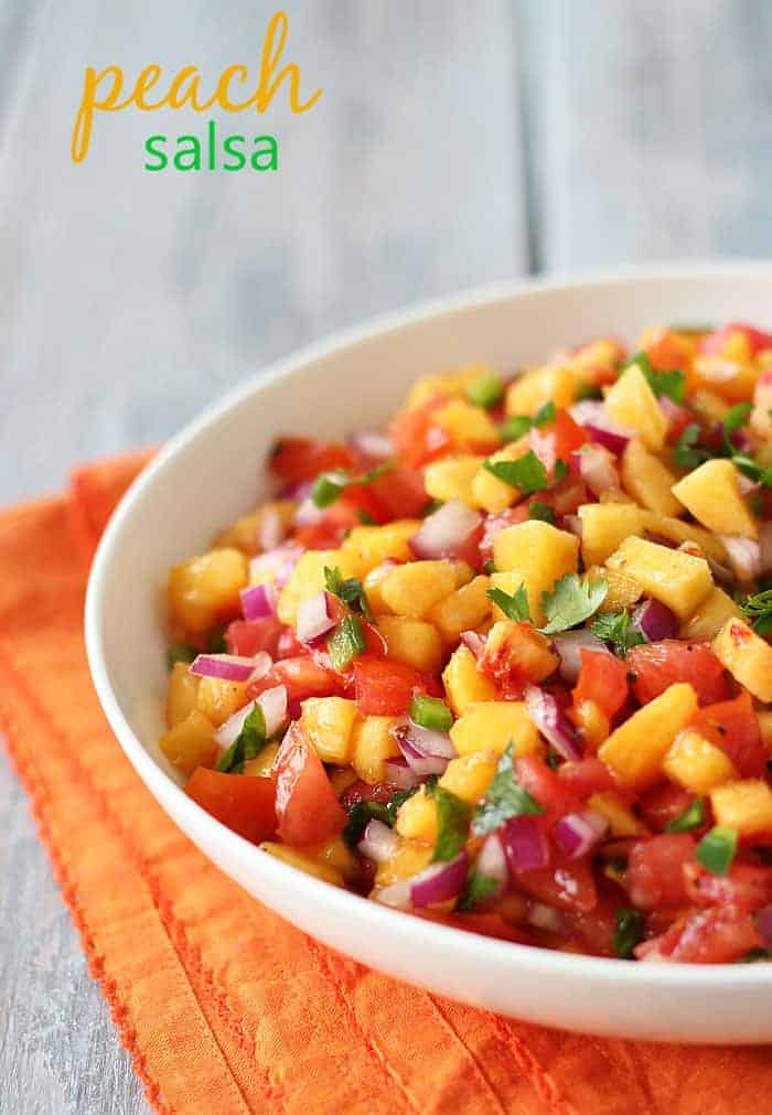 Peach salsa in a white bowl over a folded orange napkin. Overlay text at top left of image.