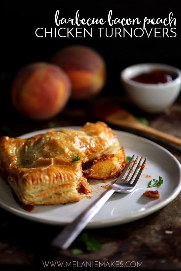 A turnover with peaches and bacon that has been cut on a white plate with a fork.