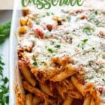 Chicken Parmesan casserole in a white baking dish with overlay text.