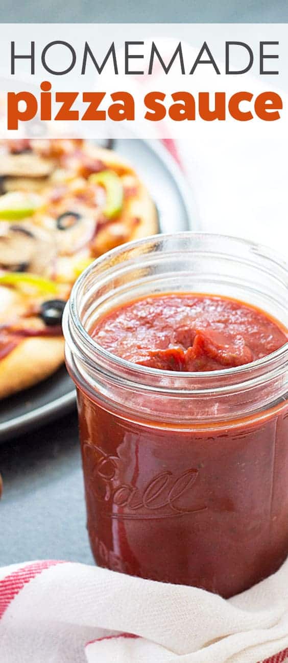 Closeup view of a jar of sauce.  A baked pizza is in the background.