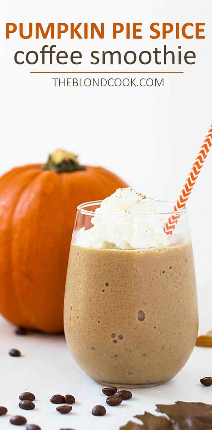 Closeup view of a coffee smoothie in a glass.  A pumpkin is in the background.