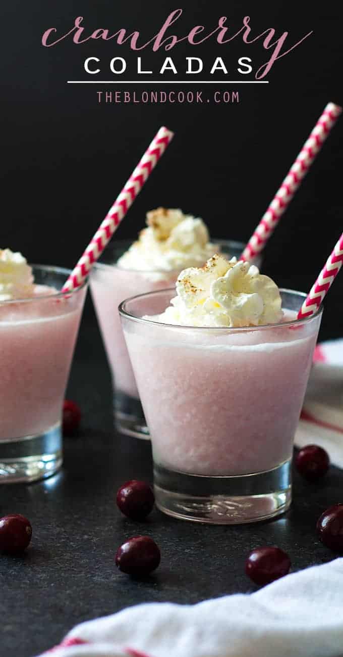 Front view of three pink frozen cocktails topped with whipped topping.