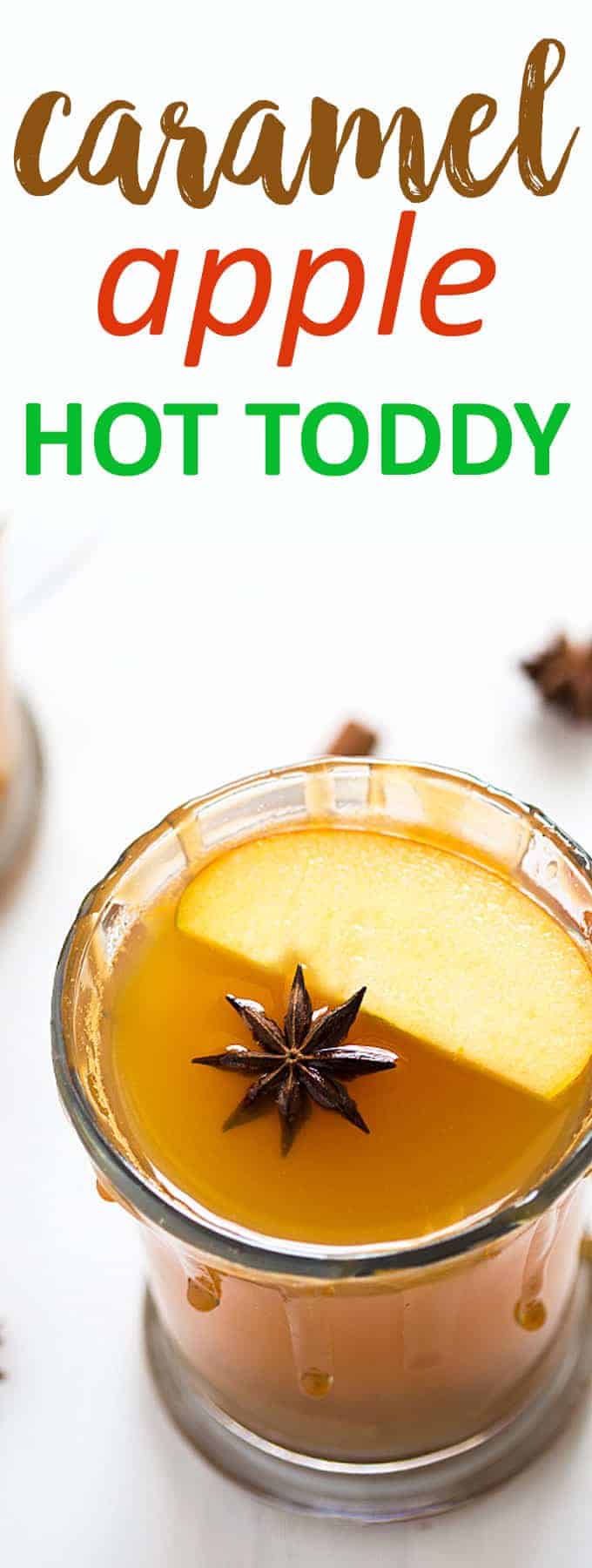 An overhead closeup view of a hot toddy with sliced apple and a star anise.