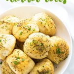 A white bowl of rolls with overlay text at top of image.