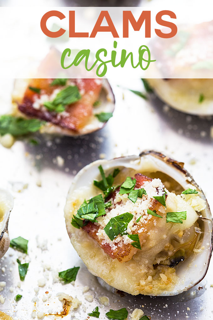 A closeup of clams casino appetizer topped with fresh chopped parsley. Overlay text at top of image.
