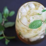 Overhead view of a julep cocktail in a glass with a sprig of fresh mint.