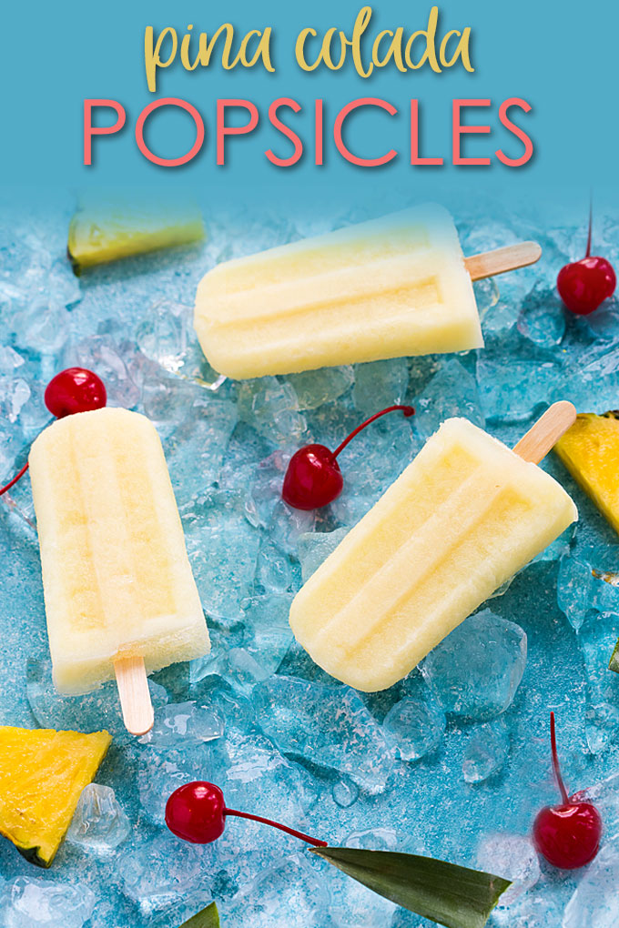 Overhead view of three pina colada popsicles on a blue surface with overlay text.