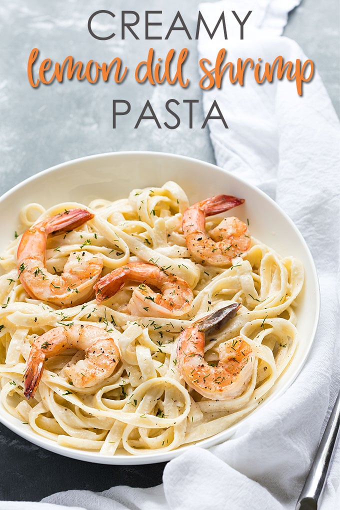 A white bowl of creamy fettuccine with shrimp.  Overlay text at top of image. 