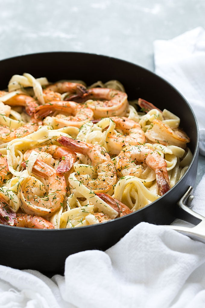 Creamy fettuccine with shrimp and dill in a skillet. 
