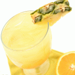 A pineapple and orange juice cocktail in a glass garnished with fresh pineapple.