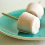 Three small popcicles on a teal plate.
