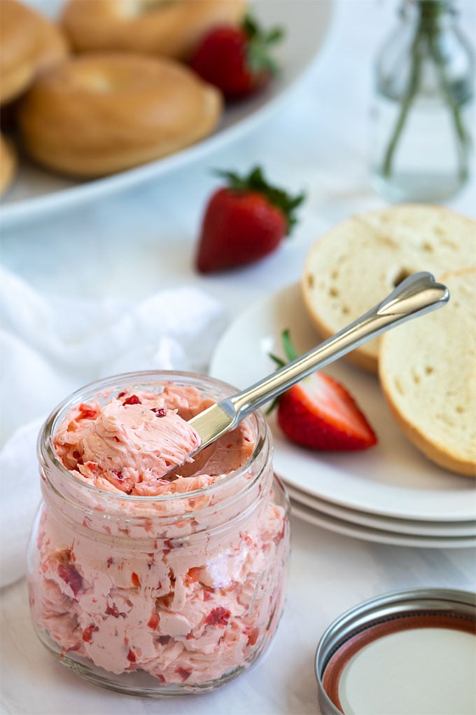 Whipped strawberry butter in a pint mason jar with a spreader knife.