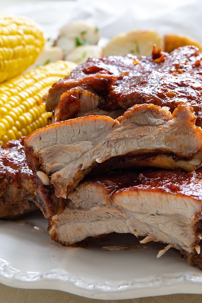 A closeup of stacked barbecue pork ribs that have been cut