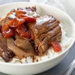 Closeup of Instant Pot Italian Pot Roast over rice in a white bowl