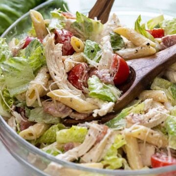 Closeup of Chicken Caesar Pasta Salad in a clear glass bowl