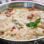 Chicken in tomato basil cream sauce in a stainless skillet
