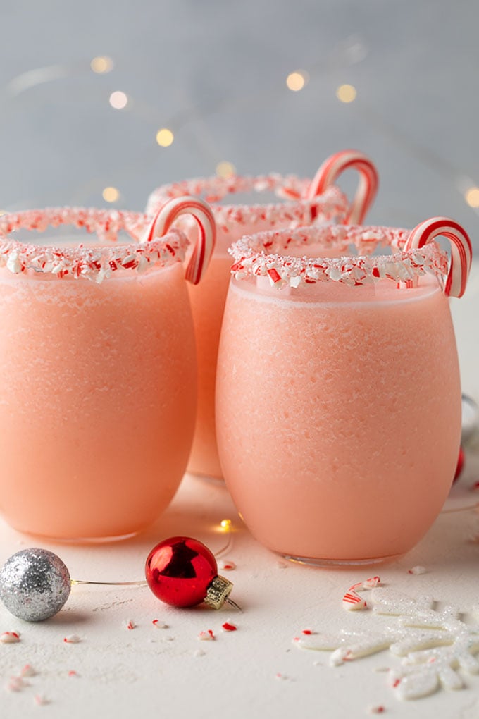 3 peppermint pina coladas in glasses rimmed with crushed candy canes