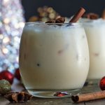 White russian cocktail prepared with eggnog and garnished with star anise and a cinnamon stick