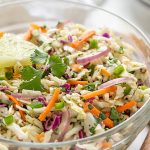 Front view of a glass bowl of Mexican coleslaw with overlay text.