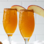Front view of two mimosas on a white tile background.
