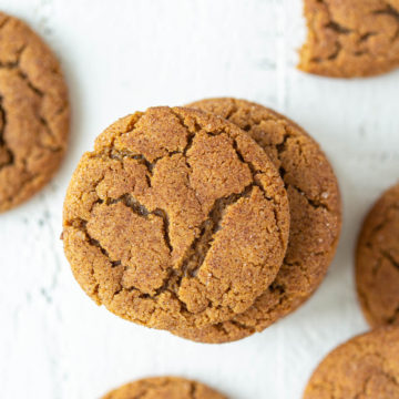 Overhead closeup view of gingersnap cookies on a white surface.