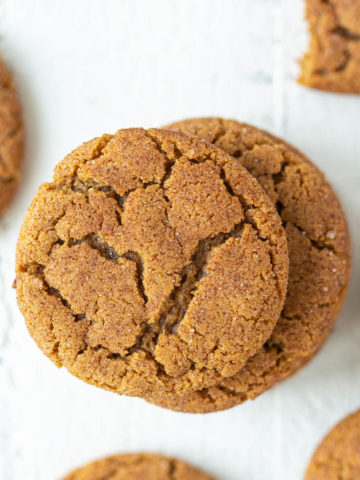 Overhead closeup view of gingersnap cookies on a white surface.
