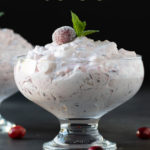 Front view of cranberry fluff in a dessert dish. Overlay text at top of image.