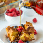 Syrup being poured over French toast casserole. Overlay text at top of image.