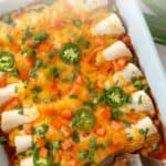 Ground beef enchiladas in a baking dish with overlay text.