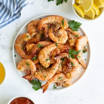 Overhead view of a plate of shrimp steamed with Old Bay Seasoning.